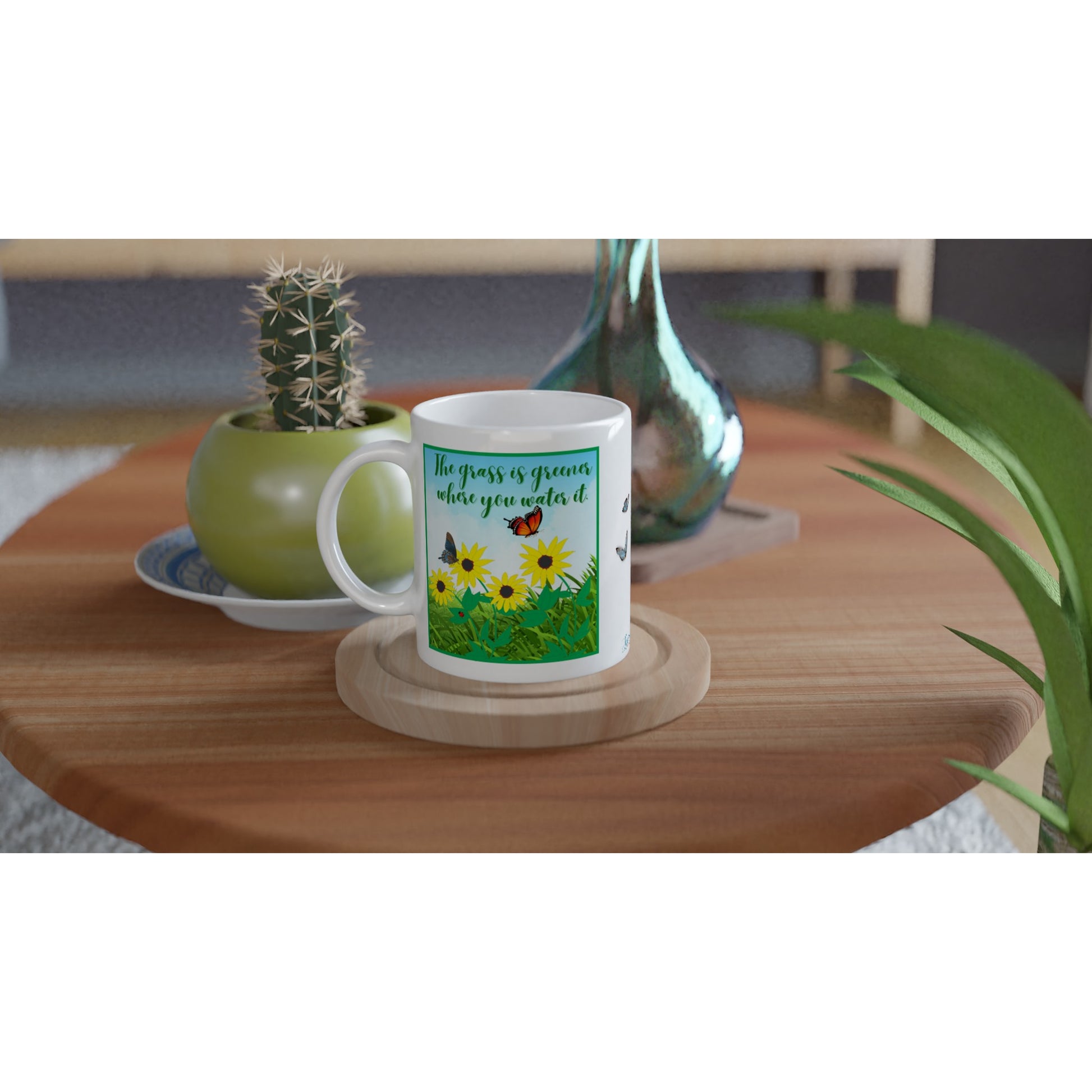 "The grass is greener where you water it." 11 oz. Mug on table