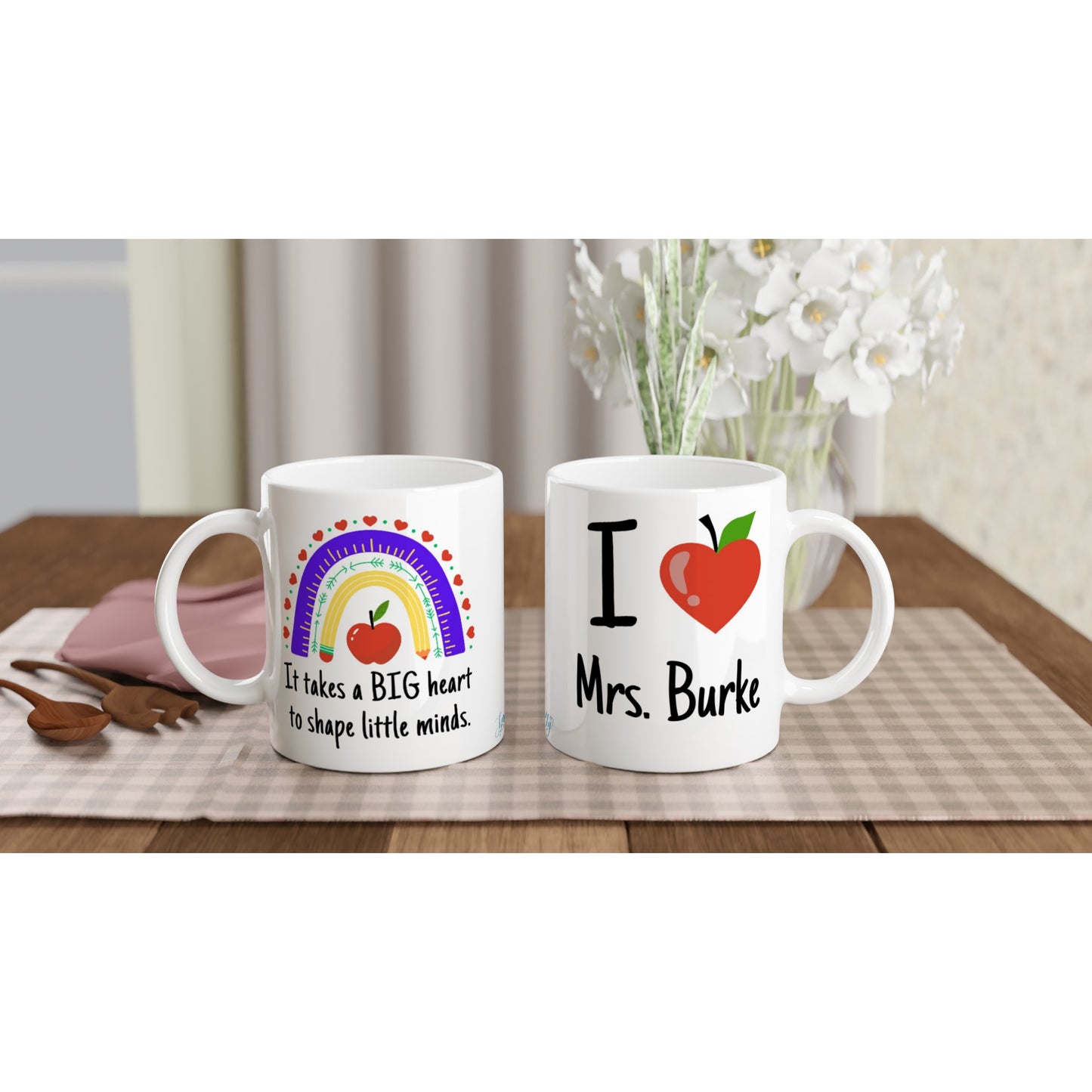 "It takes a big heart to shape little minds." Customizable Name Mug front and back view on table